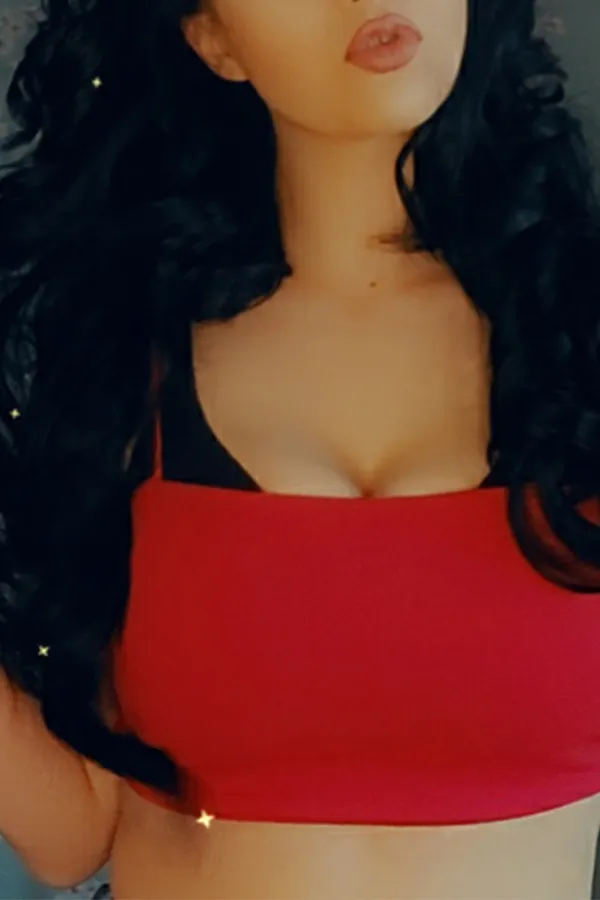 Leya showing off her red sports bra and lips. 