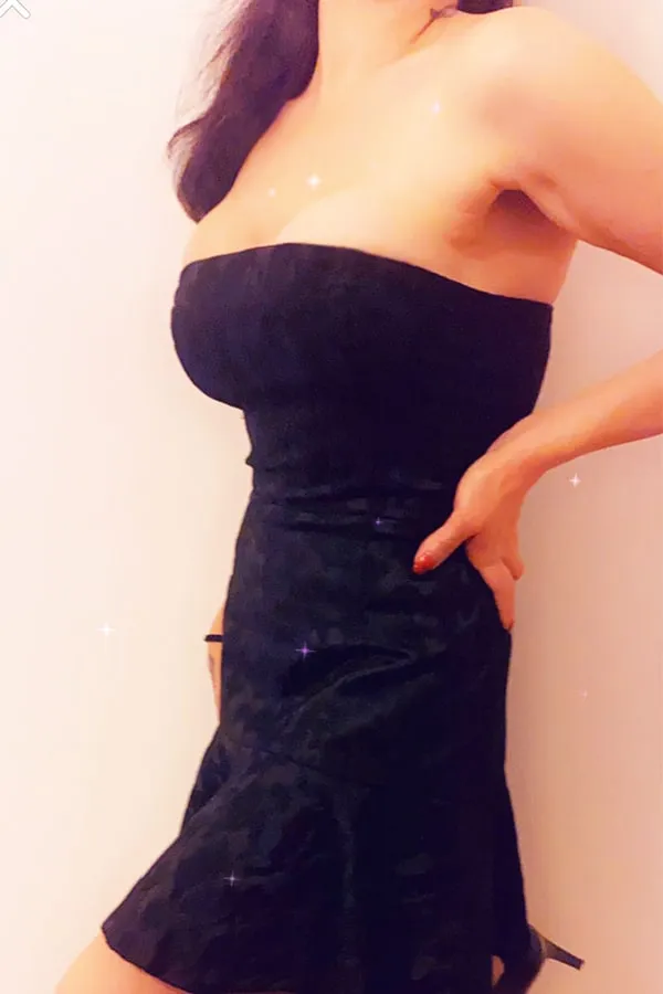 Redhead escort wearing a black dress