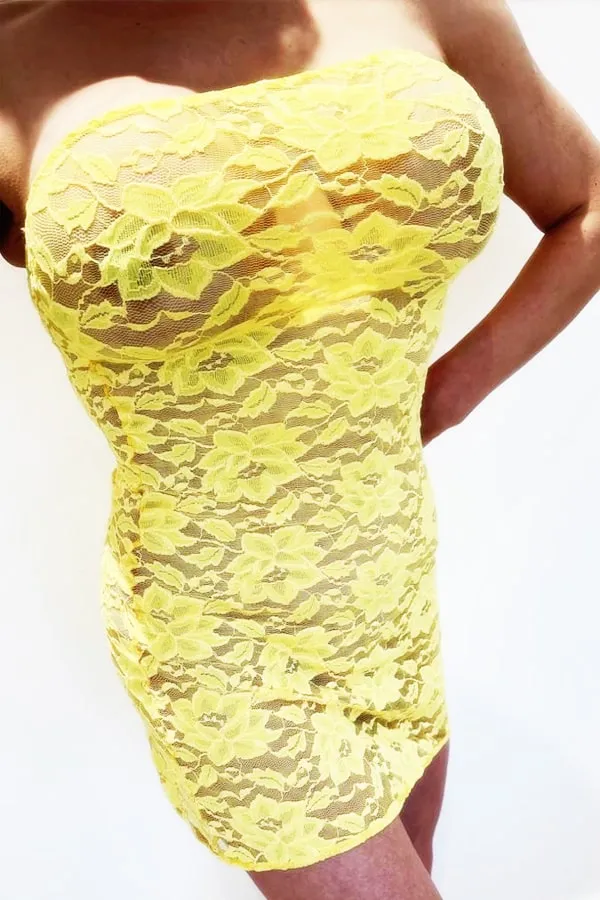 Annaliese showing off her bust in a yellow dress.